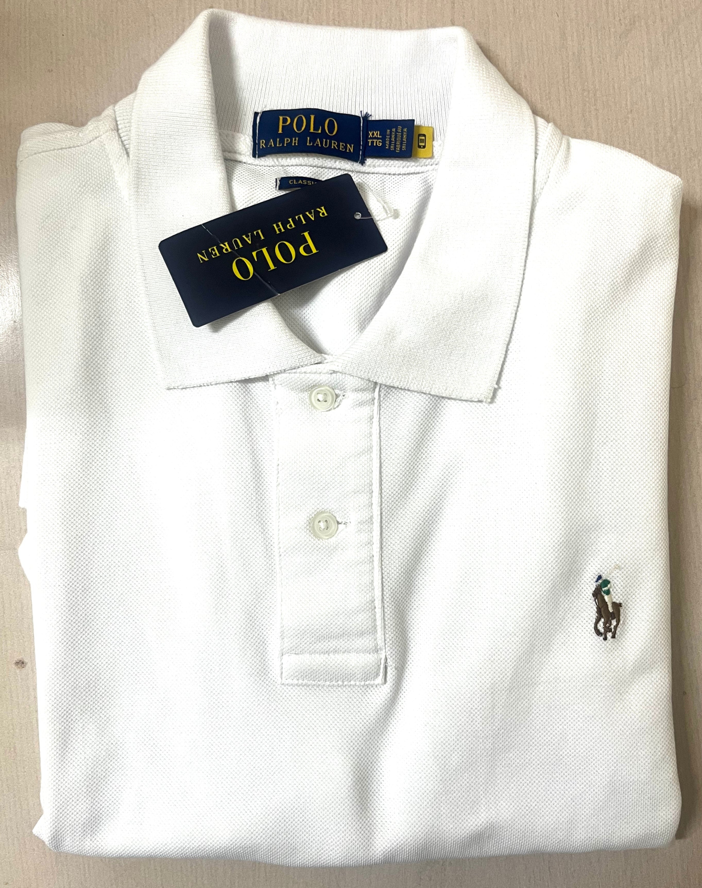 White polo shirt with Ralph Lauren logo on a beige surface
